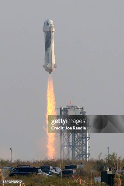 The New Shepard Blue Origin rocket lifts-off from the launch pad carrying Jeff Bezos along with his brother Mark Bezos, 18-year-old Oliver Daemen,...