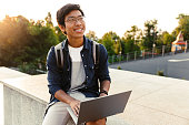 Happy asian man student with backpack