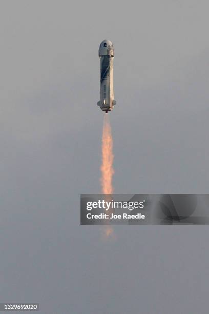 The New Shepard Blue Origin rocket lifts-off from the launch pad carrying Jeff Bezos along with his brother Mark Bezos, 18-year-old Oliver Daemen,...