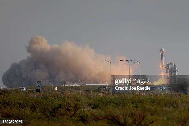 The New Shepard Blue Origin rocket lifts-off from the launch pad carrying Jeff Bezos along with his brother Mark Bezos, 18-year-old Oliver Daemen,...