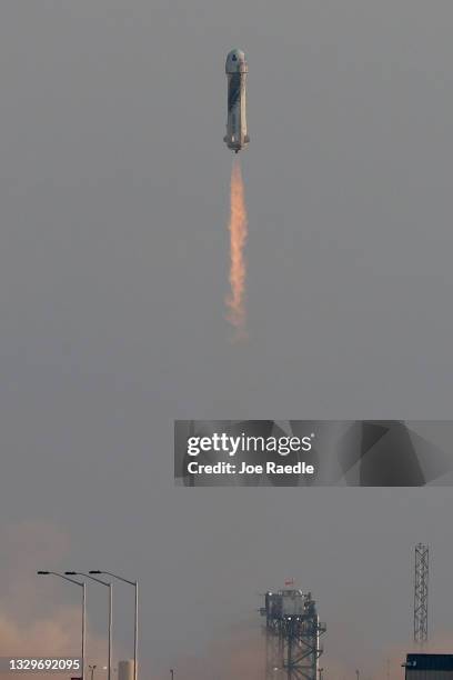 The New Shepard Blue Origin rocket lifts-off from the launch pad carrying Jeff Bezos along with his brother Mark Bezos, 18-year-old Oliver Daemen,...