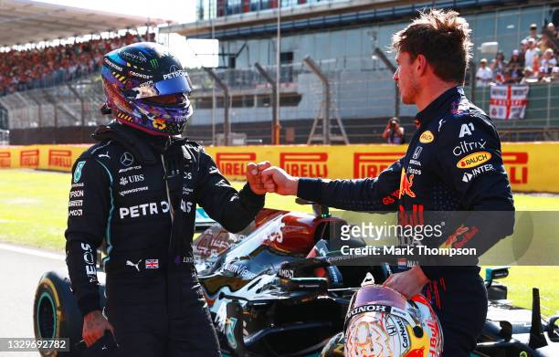 Winner Max Verstappen of Netherlands and Red Bull Racing and second placed Lewis Hamilton of Great Britain and Mercedes GP bump fists in parc ferme...