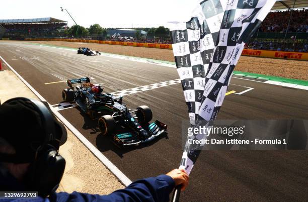 Race winner Lewis Hamilton of Great Britain driving the Mercedes AMG Petronas F1 Team Mercedes W12 takes the chequered flag during the F1 Grand Prix...