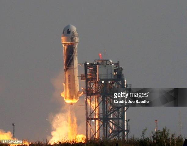 Blue Origin’s New Shepard lifts-off from the launch pad carrying Jeff Bezos along with his brother Mark Bezos, 18-year-old Oliver Daemen, and...