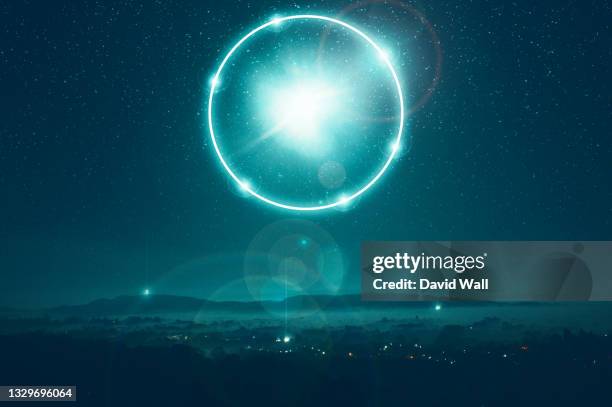 a science fiction concept of a glowing portal floating above the countryside. on a misty spooky winters night - ufo stockfoto's en -beelden