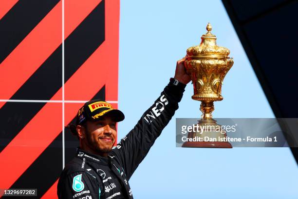 Race winner Lewis Hamilton of Great Britain and Mercedes GP celebrates on the podium after the F1 Grand Prix of Great Britain at Silverstone on July...
