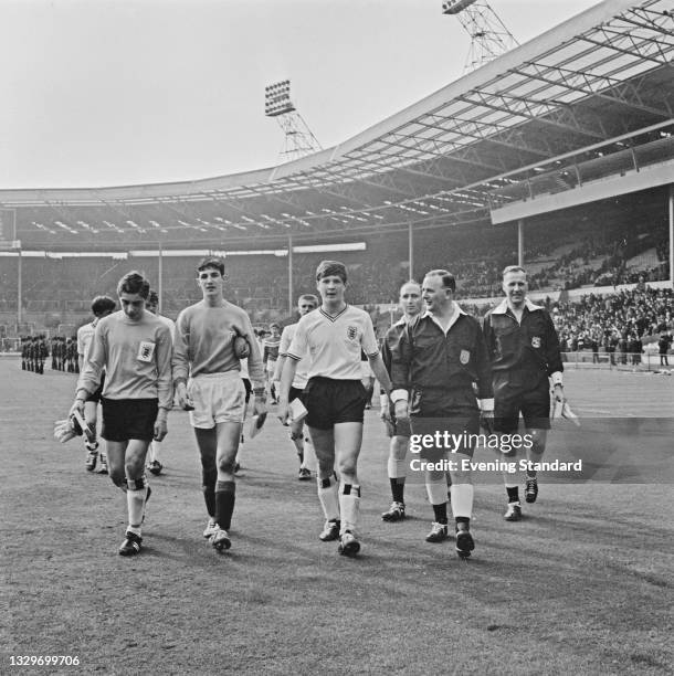 British Labour politician Denis Howell , the Minister for Sport, with members of the English Schools' Football Association team during a Schools'...