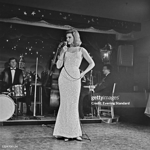 Welsh-born model and showgirl Mandy Rice-Davies in concert, UK, April 1965. She was involved in the Profumo Affair which culminated in the...