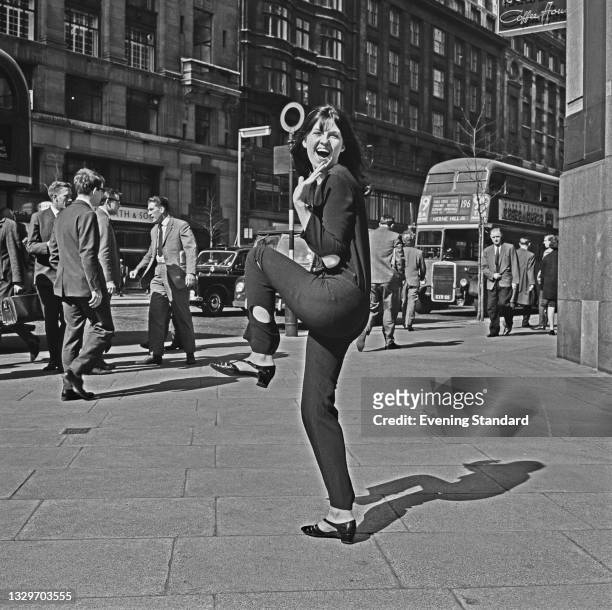 British broadcaster and television presenter Cathy McGowan poses outside the Kingsway Studios on Kingsway in London, UK, 31st March 1965. She...