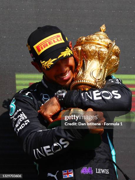 Race winner Lewis Hamilton of Great Britain and Mercedes GP celebrates on the podium after the F1 Grand Prix of Great Britain at Silverstone on July...