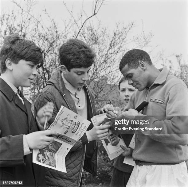 South African footballer Albert Johanneson of Leeds United signs autographs for fans the day before playing in the FA Cup final against Liverpool at...