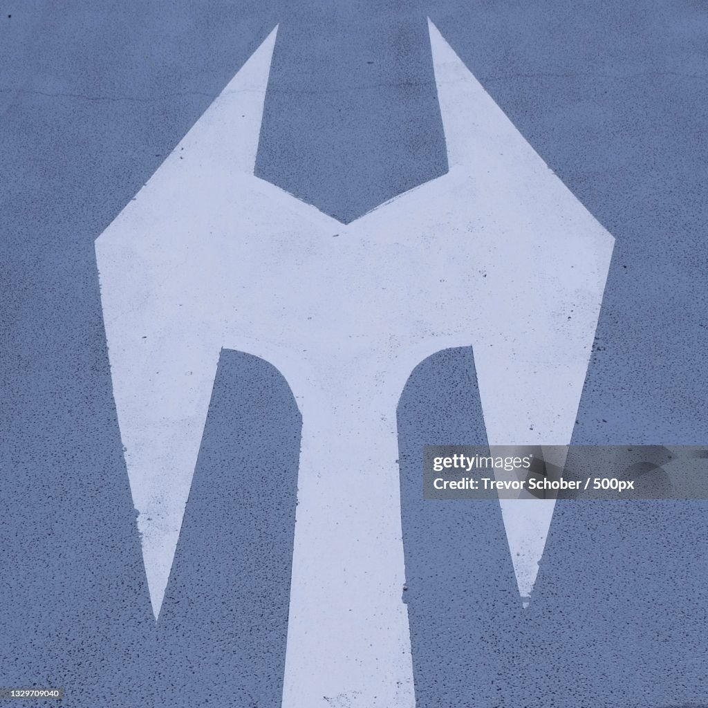 High angle view of arrow symbol on road