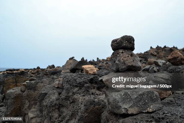 low angle view of rocks against clear sky - bagagem stock pictures, royalty-free photos & images