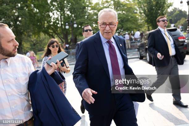 Senate Majority Leader Charles Schumer walks back to the U.S. Capitol after speaking at a press conference urging the inclusion of the Civilian...