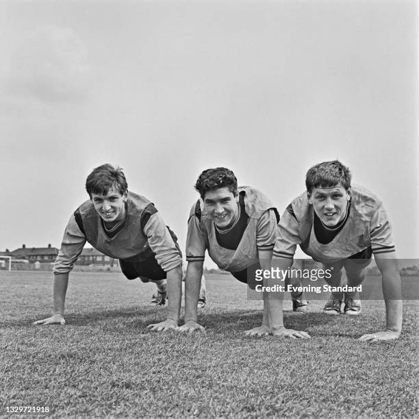 From left to right, footballers Martin Peters , Alan Sealey and Brian Dear of West Ham United take some exercise after winning the European Cup...