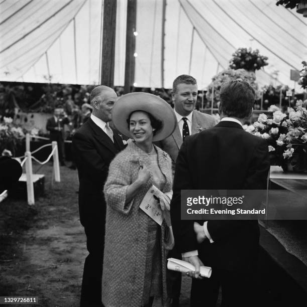 Princess Margaret and her husband Lord Snowdon visit the Sam McGredy rose stand at the Chelsea Flower Show in London, UK, 27th May 1965.