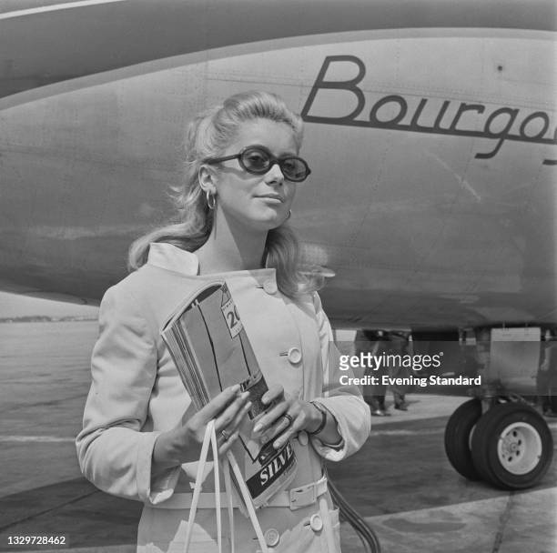 French actress Catherine Deneuve arrives at London Airport to attend the premiere of the Roman Polanski film 'Repulsion', in which she stars, UK,...