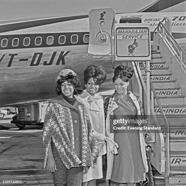 American female singing group The Supremes at London Airport in London, UK, 6th October 1964. From left to right, they are Mary Wilson, Diana Ross...