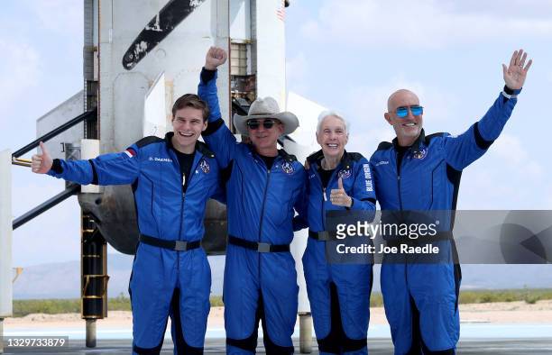 Blue Origin’s New Shepard crew Oliver Daemen, Jeff Bezos, Wally Funk, and Mark Bezos pose for a picture near the booster after flying into space in...