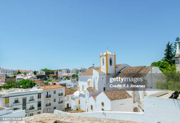 landscape of the village of tavira with church - tavira stock pictures, royalty-free photos & images