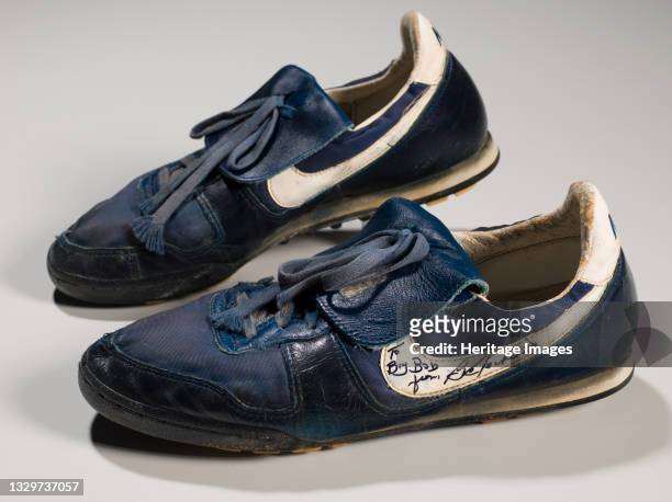 Pair of dark blue Nike athletic shoes worn by African-American professional baseball and football player Bo Jackson . The shoes have white accents...