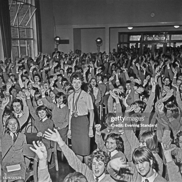 English athlete Ann Packer, a PE teacher at Coombe County Girls' School in New Malden, Surrey, surrounded by pupils from the school, UK, 2nd November...