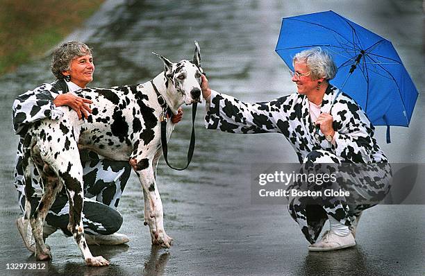 Christine Darcy, left, and her sister, Cynthia Hickson, right, fuss over Big Jay, a Harlequin Great Dane, during the MSPCA's "Mutts 'n' Fluff 'n'...