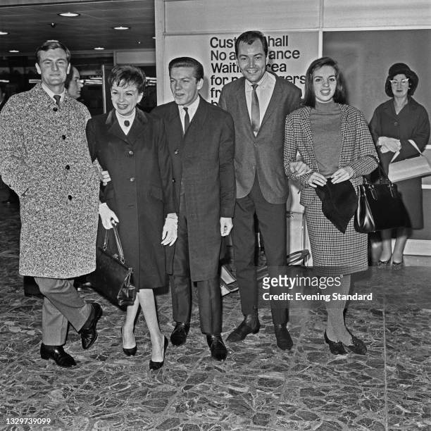 From left to right, Australian singer and musician Peter Allen , American actress and singer Judy Garland , guitarist Chris Bell, Garland's partner,...