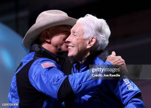 Blue Origin’s New Shepard crew Jeff Bezos and Wally Funk hug during a press conference after flying into space in the Blue Origin New Shepard rocket...