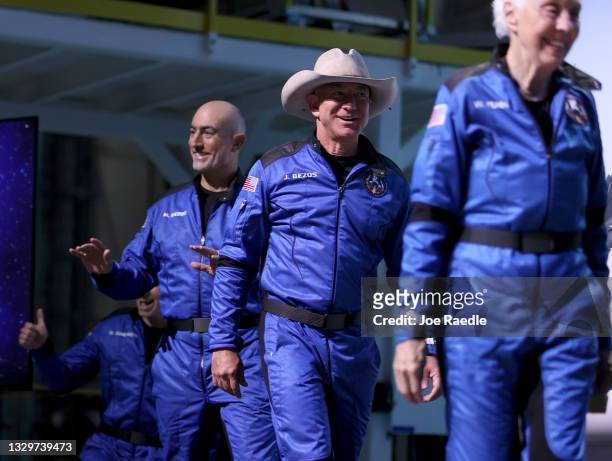 Blue Origin’s New Shepard crew Oliver Daemen , Mark Bezos, Jeff Bezos, and Wally Funk arrive for a press conference after flying into space in the...