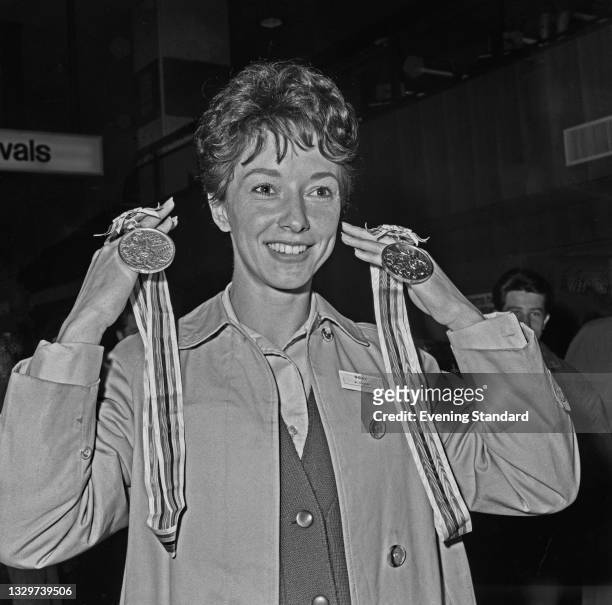 English athlete Ann Packer at Heathrow Airport in London upon her return from the 1964 Summer Olympics in Tokyo, UK, 27th October 1964. She is...