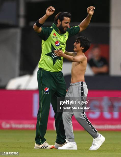 Young fan runs on to the pitch to give Pakistan player Imad Wasim a hug during the 3rd Vitality T20 match between England and Pakistan at Emirates...