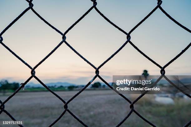 background trapped behind bars - 鉄格子 ストックフォトと画像