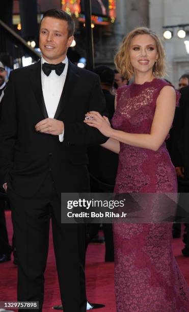 Actress Scarlett Johansson arrives with her agent, Joe Machota, on the red carpet at the Kodak Theater during the 83rd Academy Awards show, February...