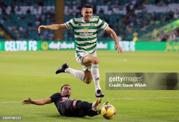 Tom Rogic of Celtic is tackled by Evander of FC Midtylland during the UEFA Champions League Second Qualifying Round First Leg between Celtic and FC...