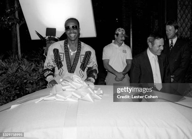 American rapper, dancer, record producer and entrepreneur MC Hammer and American music industry executive Joe Smith reveal his new Ferrari circa 1990...