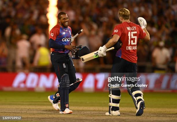 Chris Jordan of England celebrates hitting the winning runs with David Willey to win the Third Vitality International T20 match between England and...