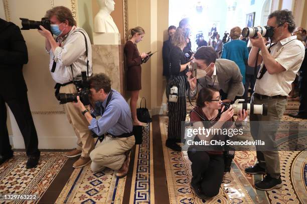 Photojournalists make images in the hallway outside the Senate Chamber following the weekly policy luncheon at the U.S. Capitol on July 20, 2021 in...