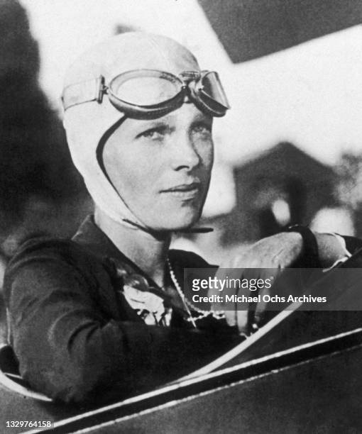 Aviatrix Amelia Earhart poses for a portrait in her plane circa 1925.