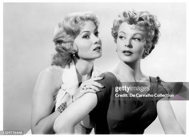 Actress Rhonda Fleming as 'June Lyons' and Actress Arlene Dahl as 'Dorothy Lyons' in a publicity shot from the movie 'Slightly Scarlet' United States.