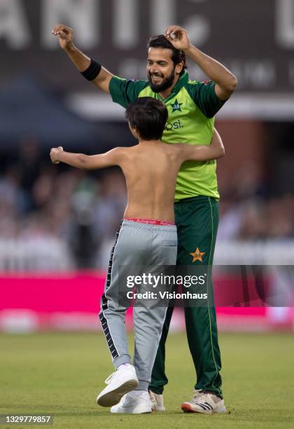 Imad Wasim of Pakistan tries to avoid a pitch invader during the 3rd T20I between England and Pakistan at Emirates Old Trafford on July 20, 2021 in...