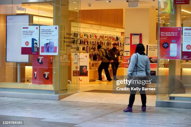 Telstra shop in Rundle Mall services a customer on July 21, 2021 in Adelaide, Australia. South Australia is in lockdown after a cluster of covid-19...