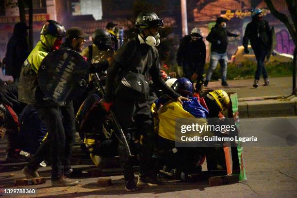 Members of the loose collective of protesters called Primera Linea clash with riot police during anti-government protests on July 20, 2021 in Bogota,...