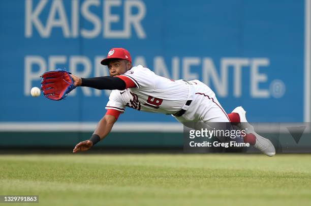 Victor Robles of the Washington Nationals tries to catch a single hit by Miguel Rojas of the Miami Marlins in the first inning at Nationals Park on...