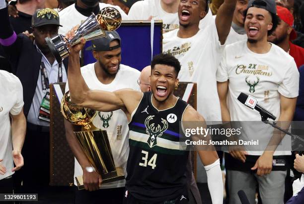 Giannis Antetokounmpo of the Milwaukee Bucks celebrates winning the Bill Russell NBA Finals MVP Award after defeating the Phoenix Suns in Game Six to...