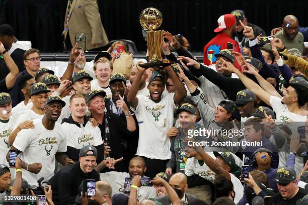 Khris Middleton and members of the Milwaukee Bucks celebrate after defeating the Phoenix Suns in Game Six to win the 2021 NBA Finals at Fiserv Forum...