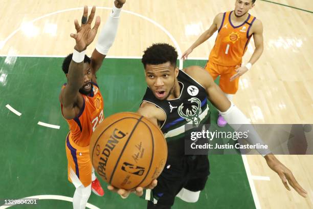 Giannis Antetokounmpo of the Milwaukee Bucks goes up for a shot against Deandre Ayton of the Phoenix Suns during the second half in Game Six of the...