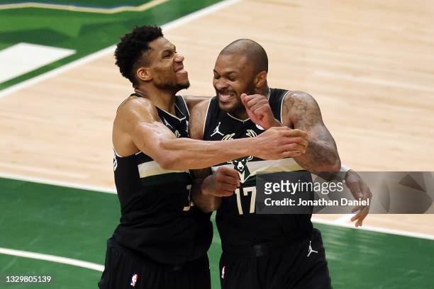 Giannis Antetokounmpo of the Milwaukee Bucks celebrates with teammate P.J. Tucker in the final seconds before defeating the Phoenix Suns in Game Six...