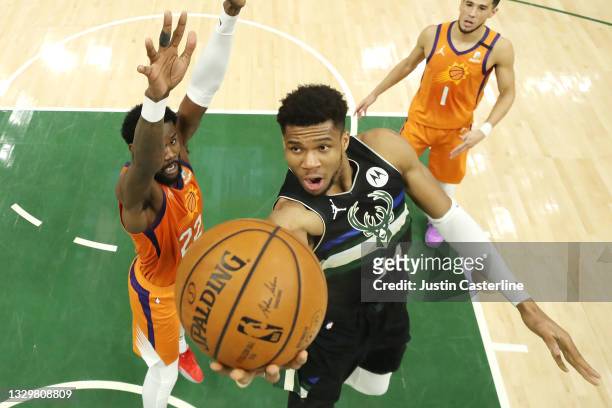 Giannis Antetokounmpo of the Milwaukee Bucks goes up for a shot against Deandre Ayton of the Phoenix Suns during the second half in Game Six of the...