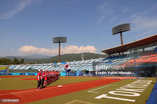 General view of Team Australia and Team Japan standing in the infield for pregame ceremonies before to their game during the Tokyo 2020 Olympic Games...